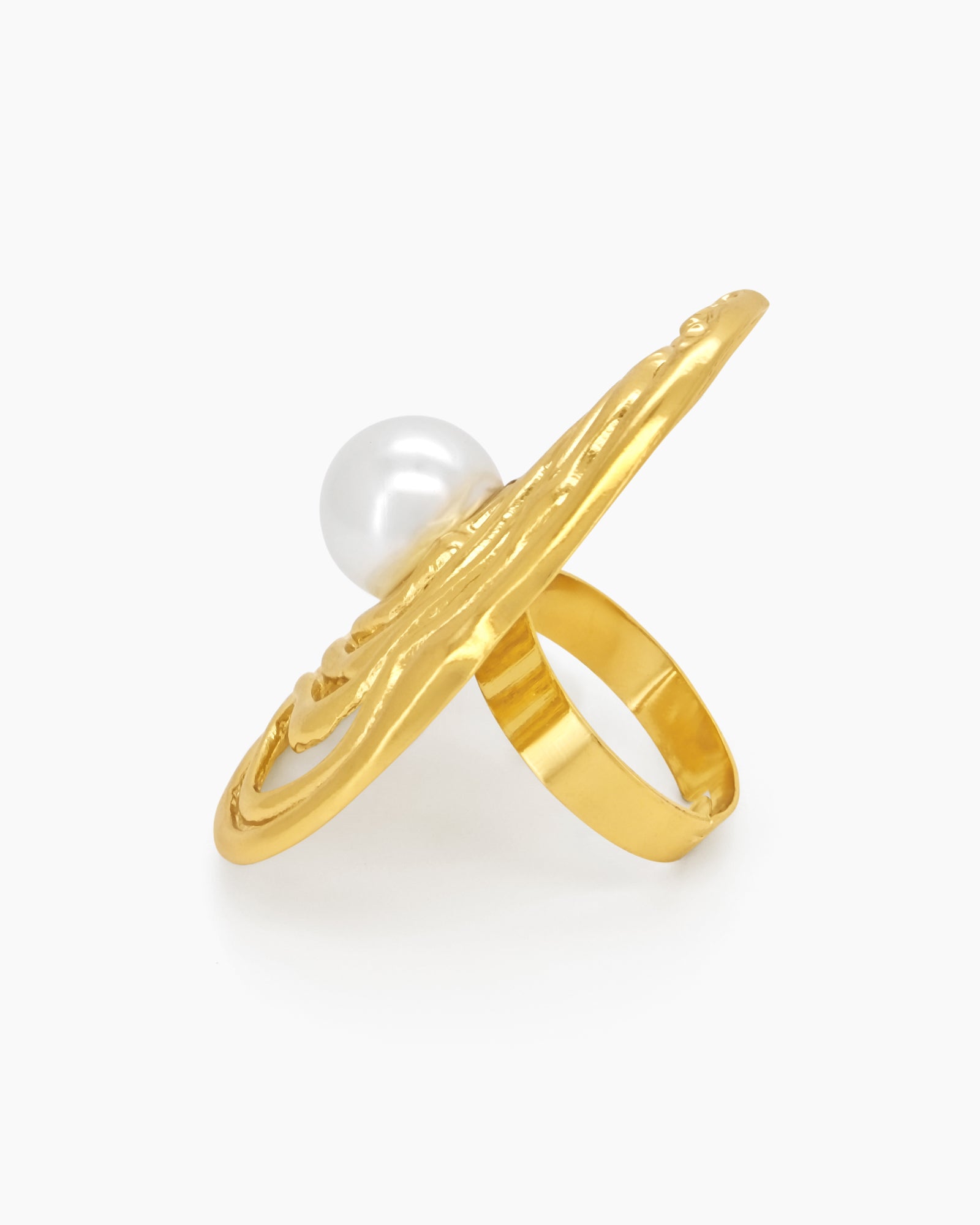 A sculptural gold ring with an abstract shell design cradling a luminous faux pearl