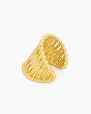 An airy gold statement ring with wavy, openwork bands and an adjustable fit