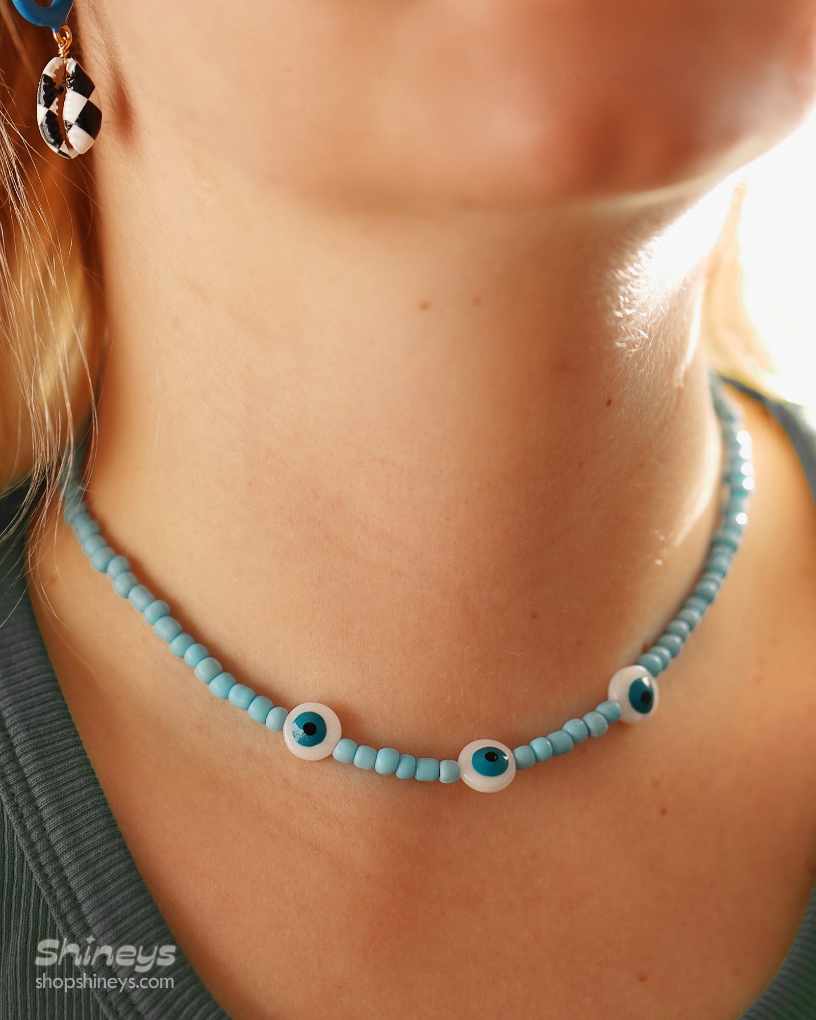 The Azure Evil Eye Beaded Necklace paired with the Corsica Plaid Shell Earrings