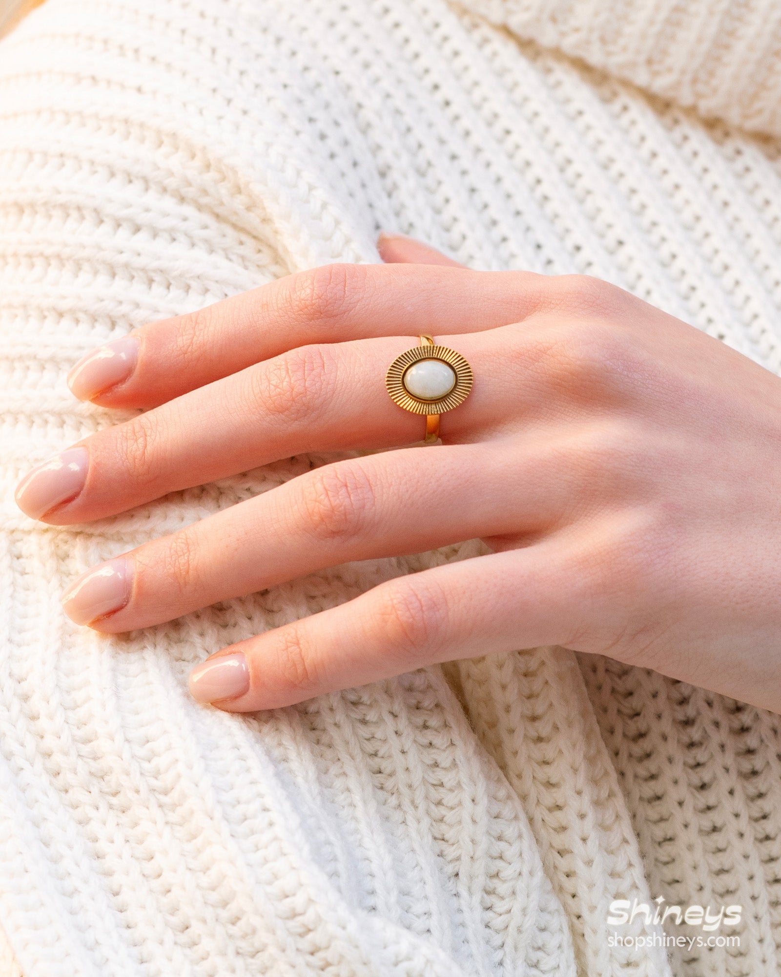 A White Amazonite adjustable ring with a radiant gold-toned band and fine sunburst detailing
