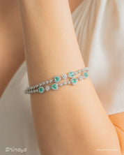 A radiant lake-blue vintage-style bracelet with two rows of zircons and five haloed heart-shaped centerpieces