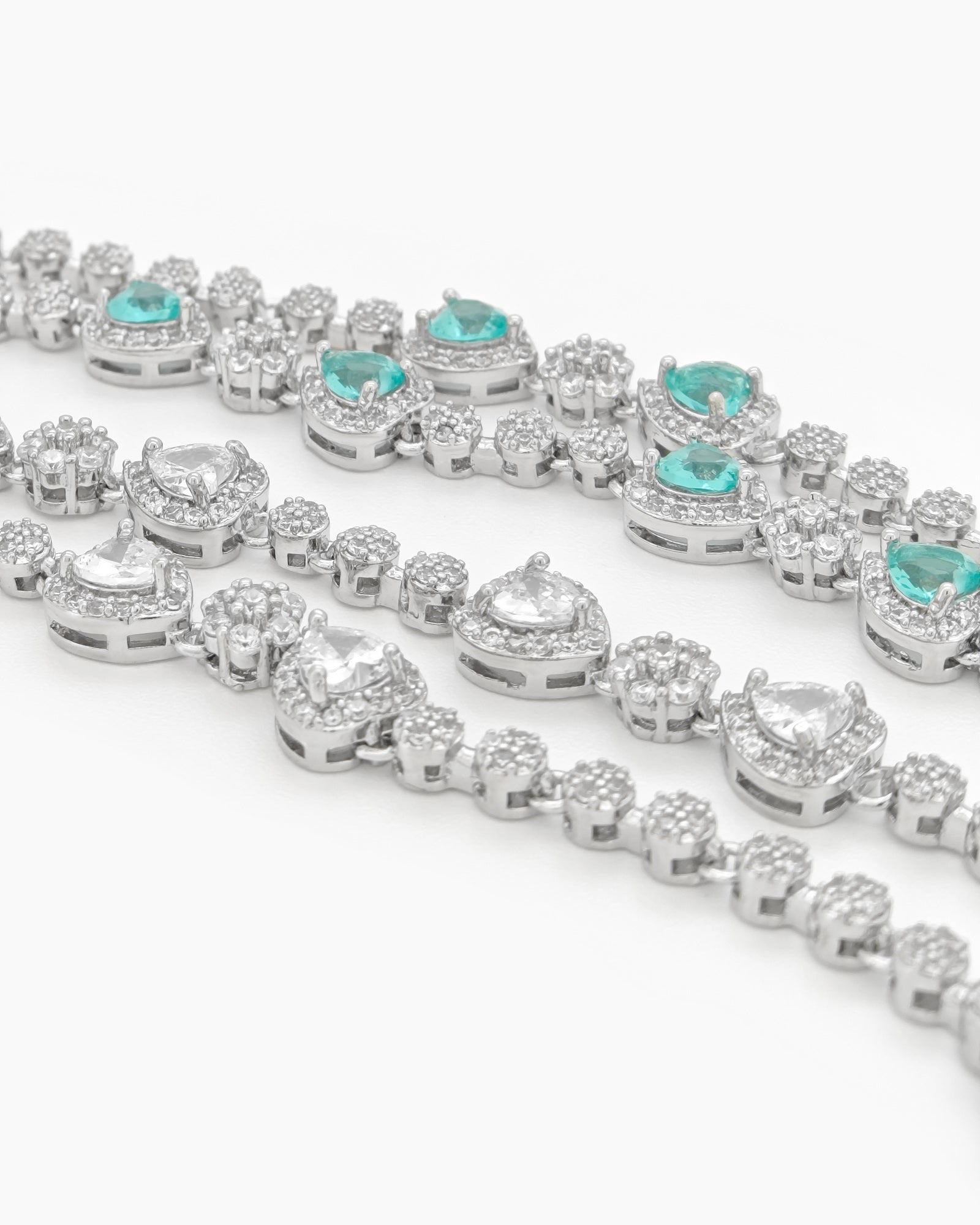 A radiant lake-blue vintage-style bracelet with two rows of zircons and five haloed heart-shaped centerpieces