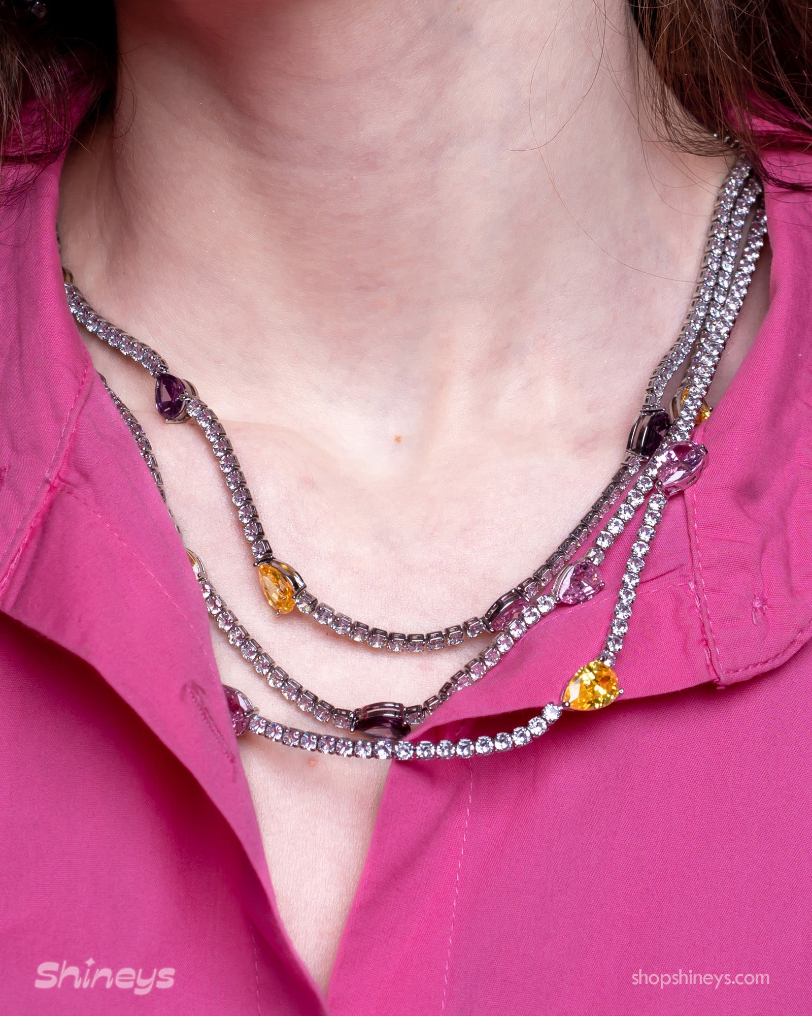 A set with a cascade of three crystal rows, teardrop-shaped zircon stones, and coordinating earrings