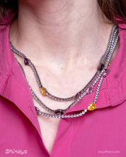 A set with a cascade of three crystal rows, teardrop-shaped zircon stones, and coordinating earrings