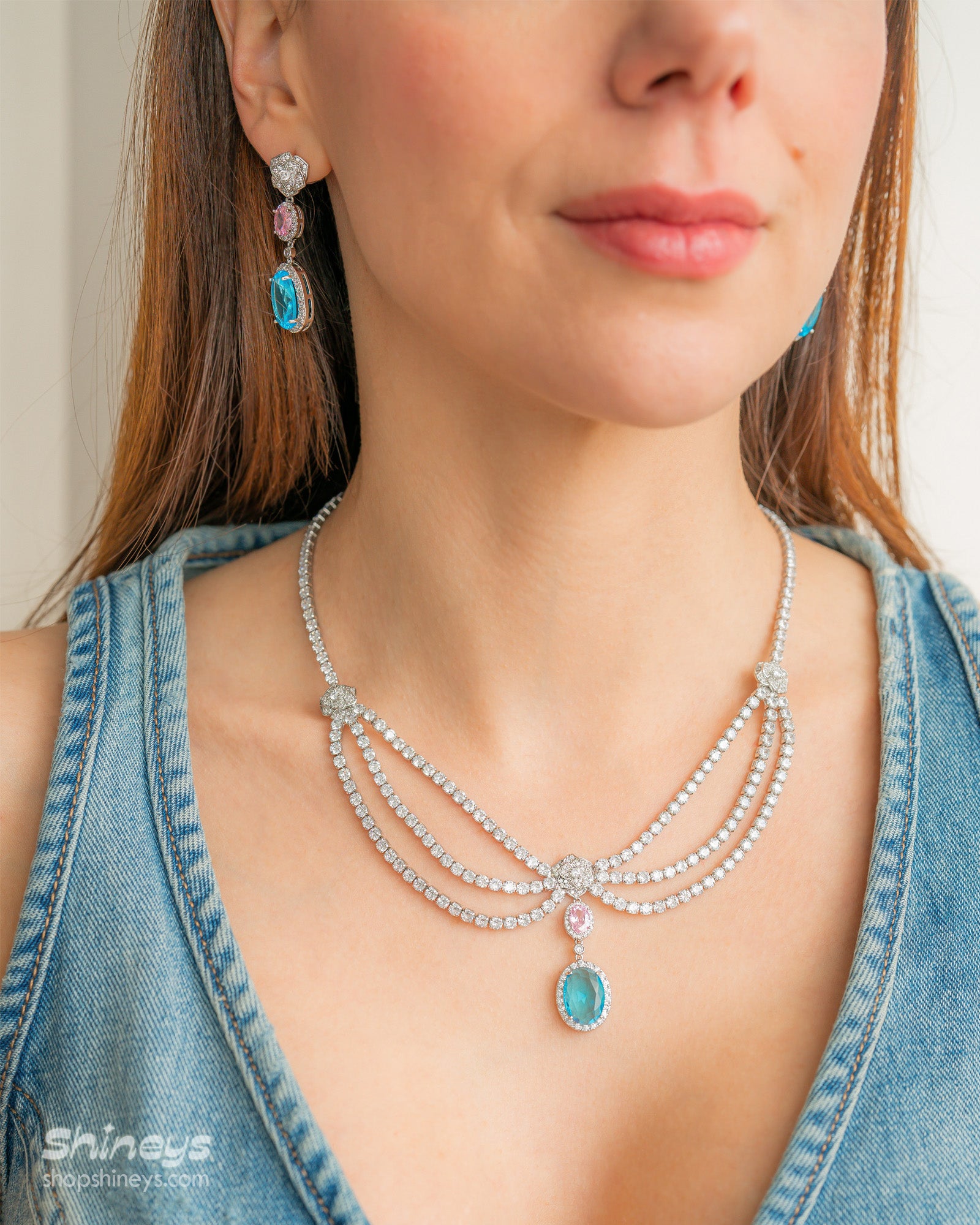 A set with a cascading esclavage-style necklace and matching earrings in soft pink and ocean-blue drops