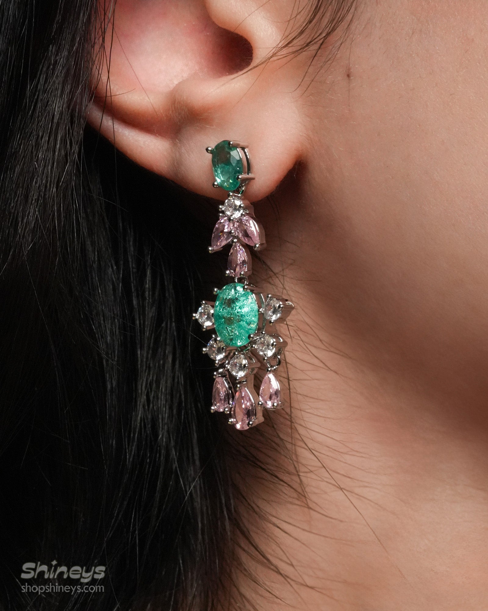 A jewelry set with radiant green oval zircons flanked by whimsical pink and white gemstone accents