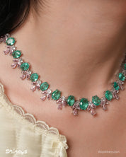 A jewelry set with radiant green oval zircons flanked by whimsical pink and white gemstone accents