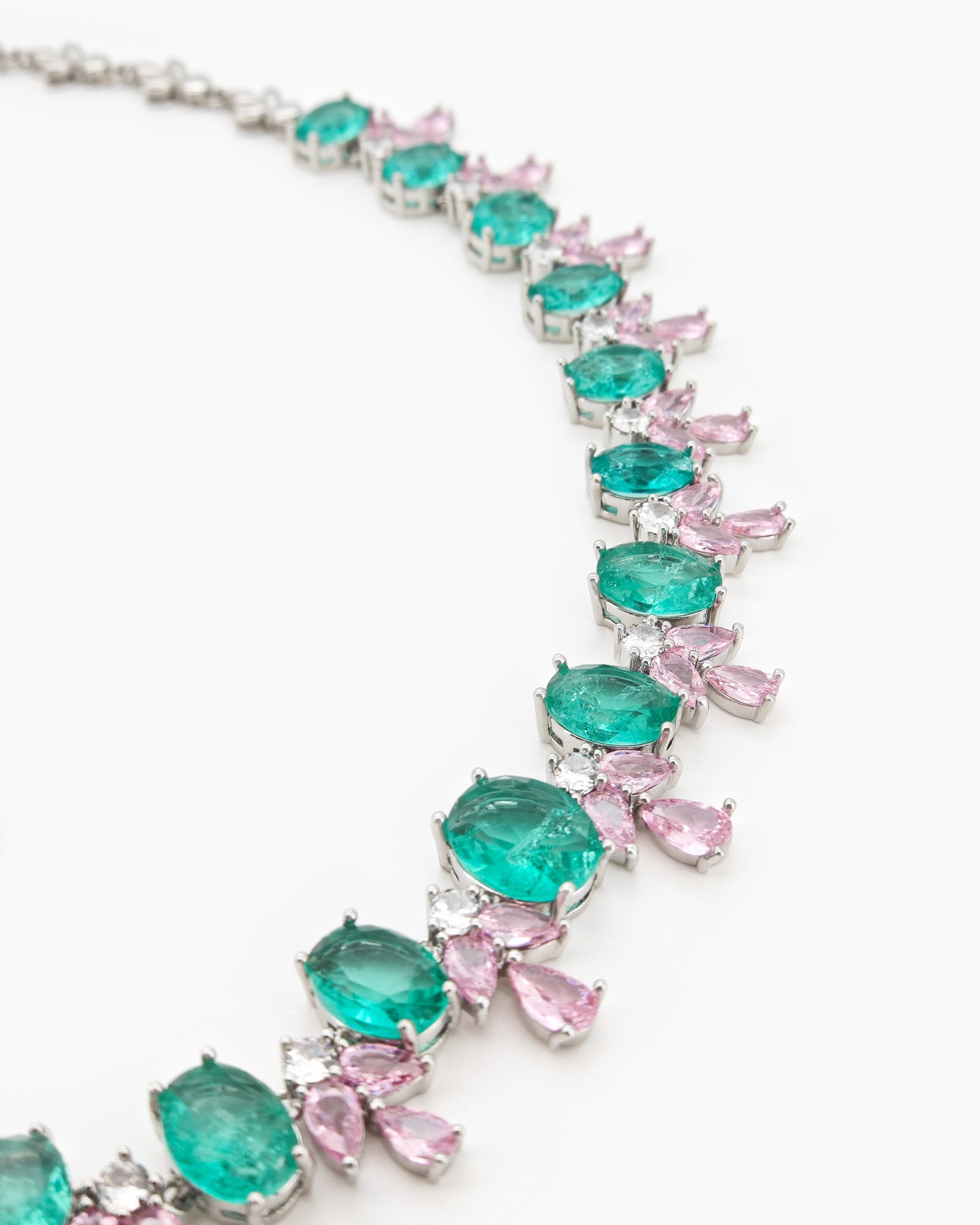 A jewelry set with radiant green oval zircons flanked by whimsical pink and white gemstone accents