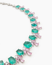 A jewelry set with radiant green oval zircons flanked by whimsical pink and white gemstone accents