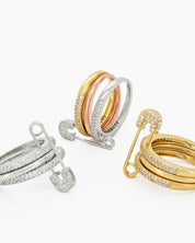 A gold stacked band ring with a crystal-studded safety pin detail for a stylish, daring twist