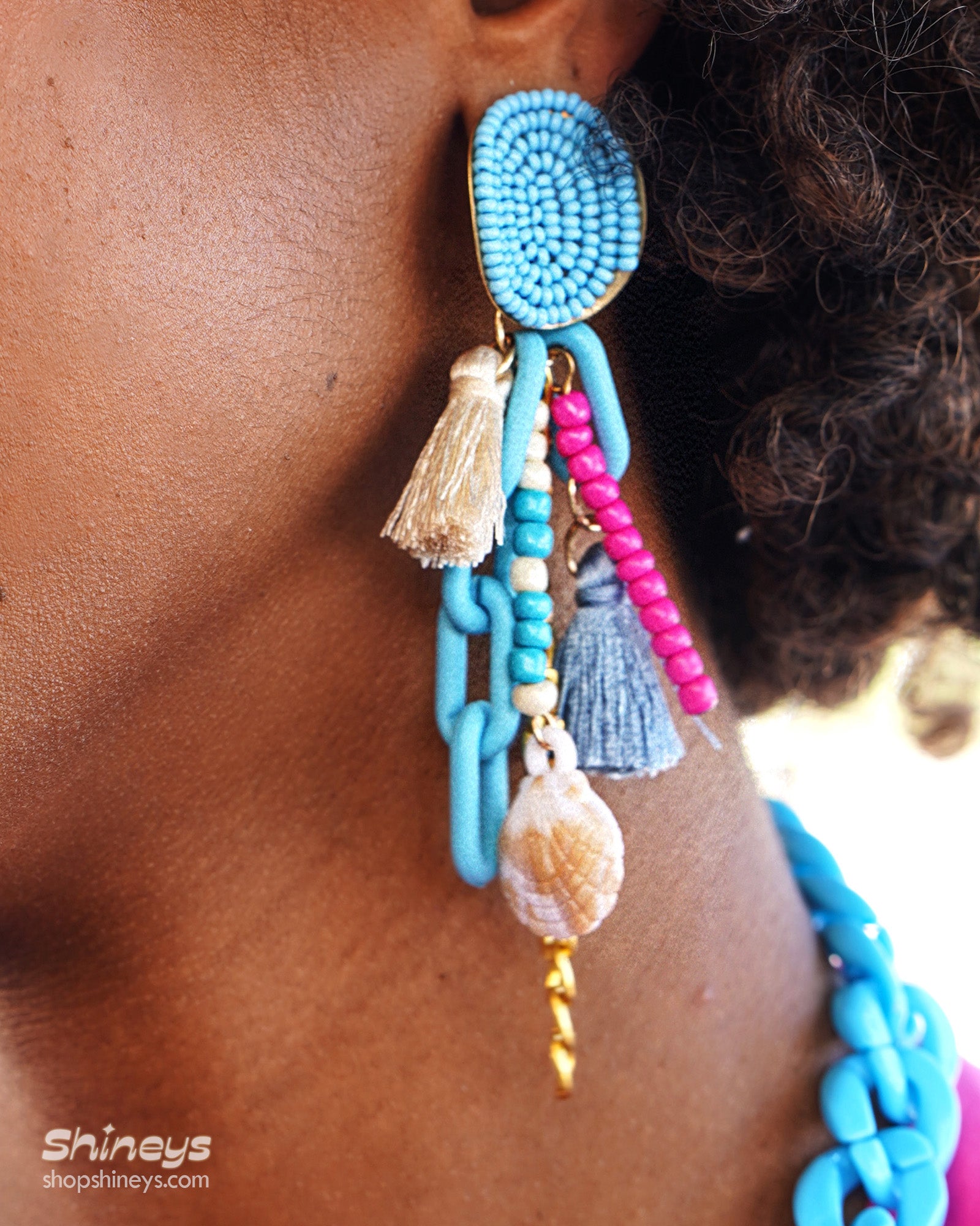 Earrings with a joyful explosion of sky-blue beads, candy-colored strands, and chunky links