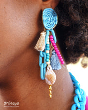 Earrings with a joyful explosion of sky-blue beads, candy-colored strands, and chunky links