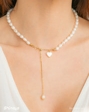 A necklace with a graceful strand of freshwater pearls and a mother-of-pearl heart charm