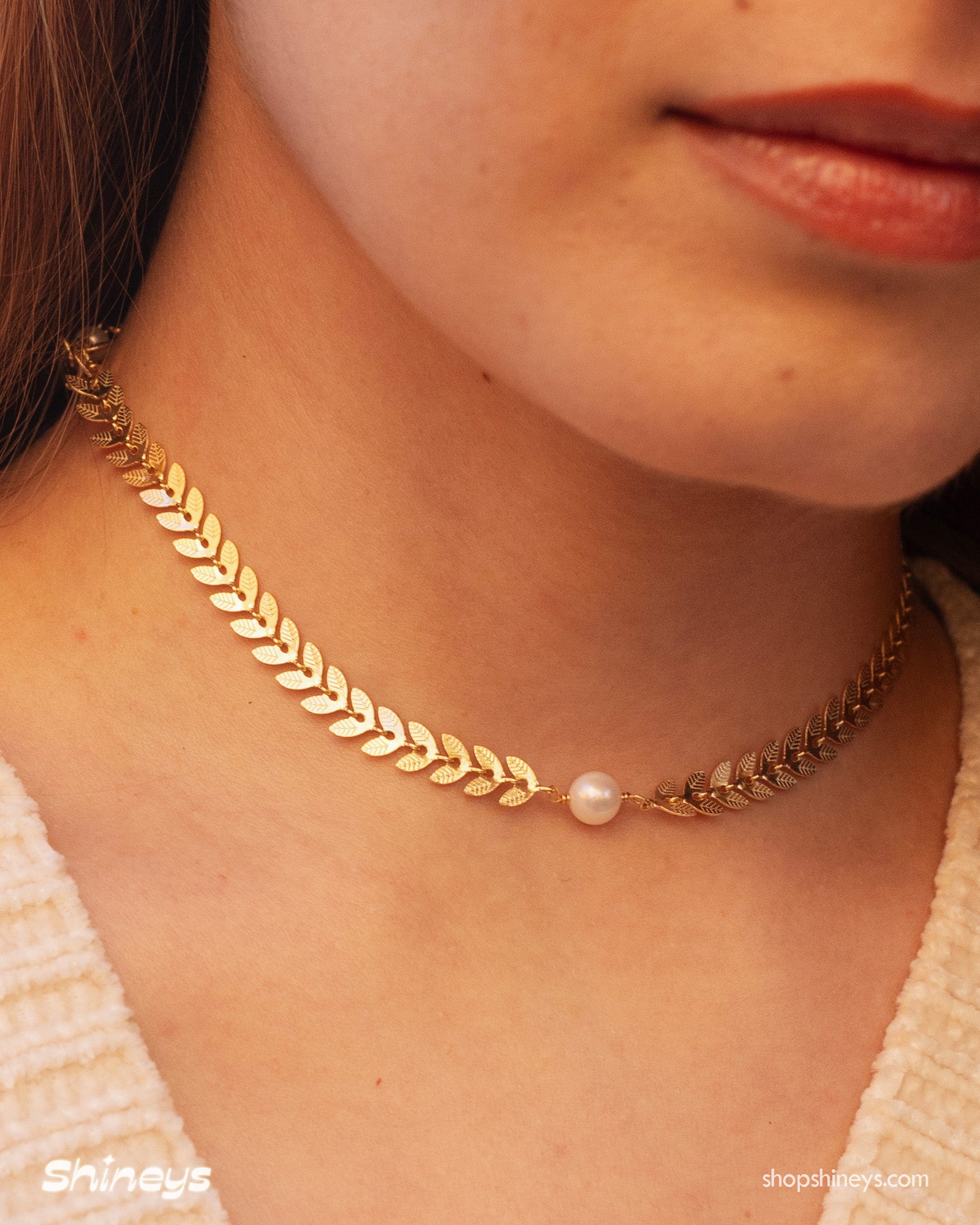 A choker of fine laurel leaves in a graceful silhouette, accented with lustrous pearls