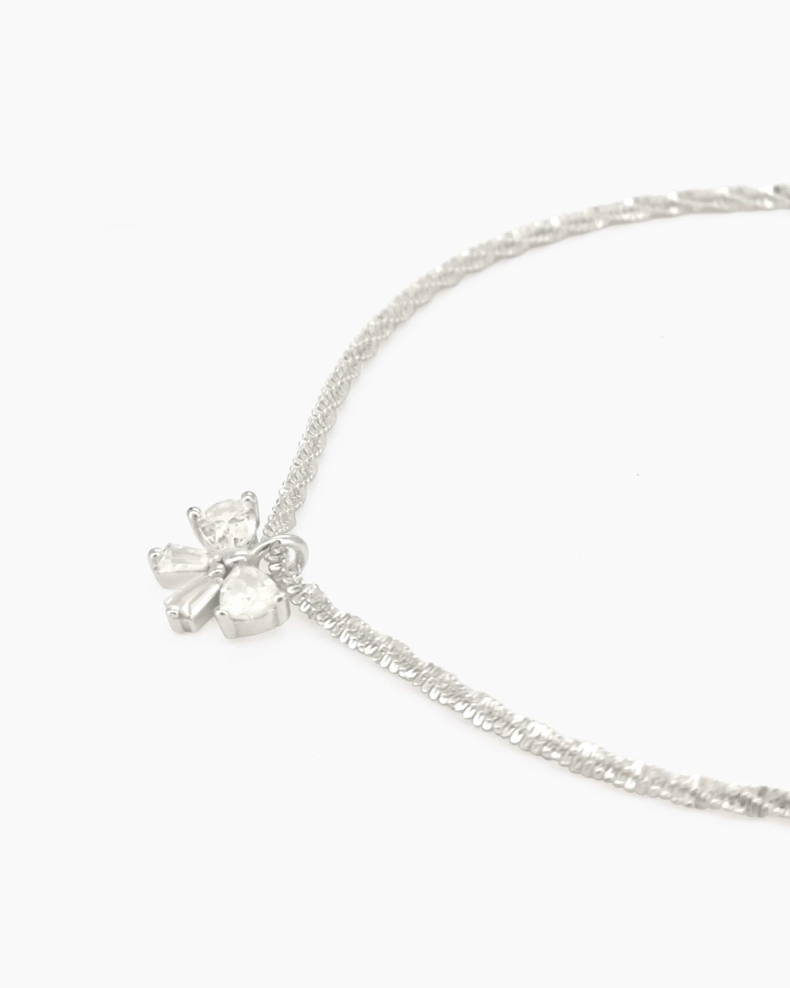 A minimalist bracelet with a shimmering diamond-cut silver chain finished with a dainty zircon bow