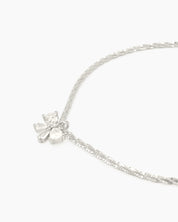 A minimalist bracelet with a shimmering diamond-cut silver chain finished with a dainty zircon bow