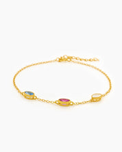 An elegant bracelet with three bezel-set oval zircons, each in a unique hue, on a fine cable chain