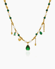A necklace weaving together deep green zircons, freshwater pearls, and delicate jade beads