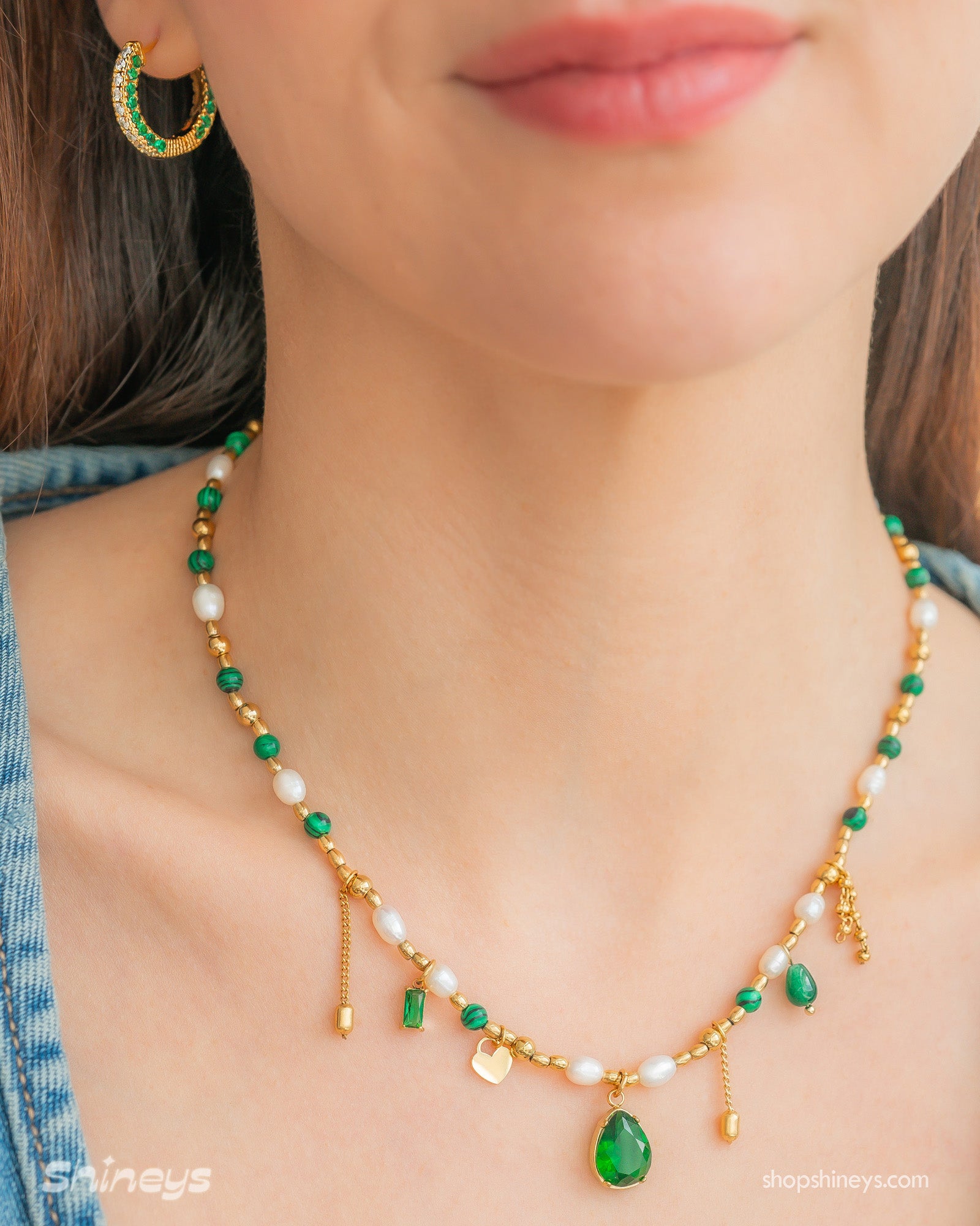 A necklace weaving together deep green zircons, freshwater pearls, and delicate jade beads