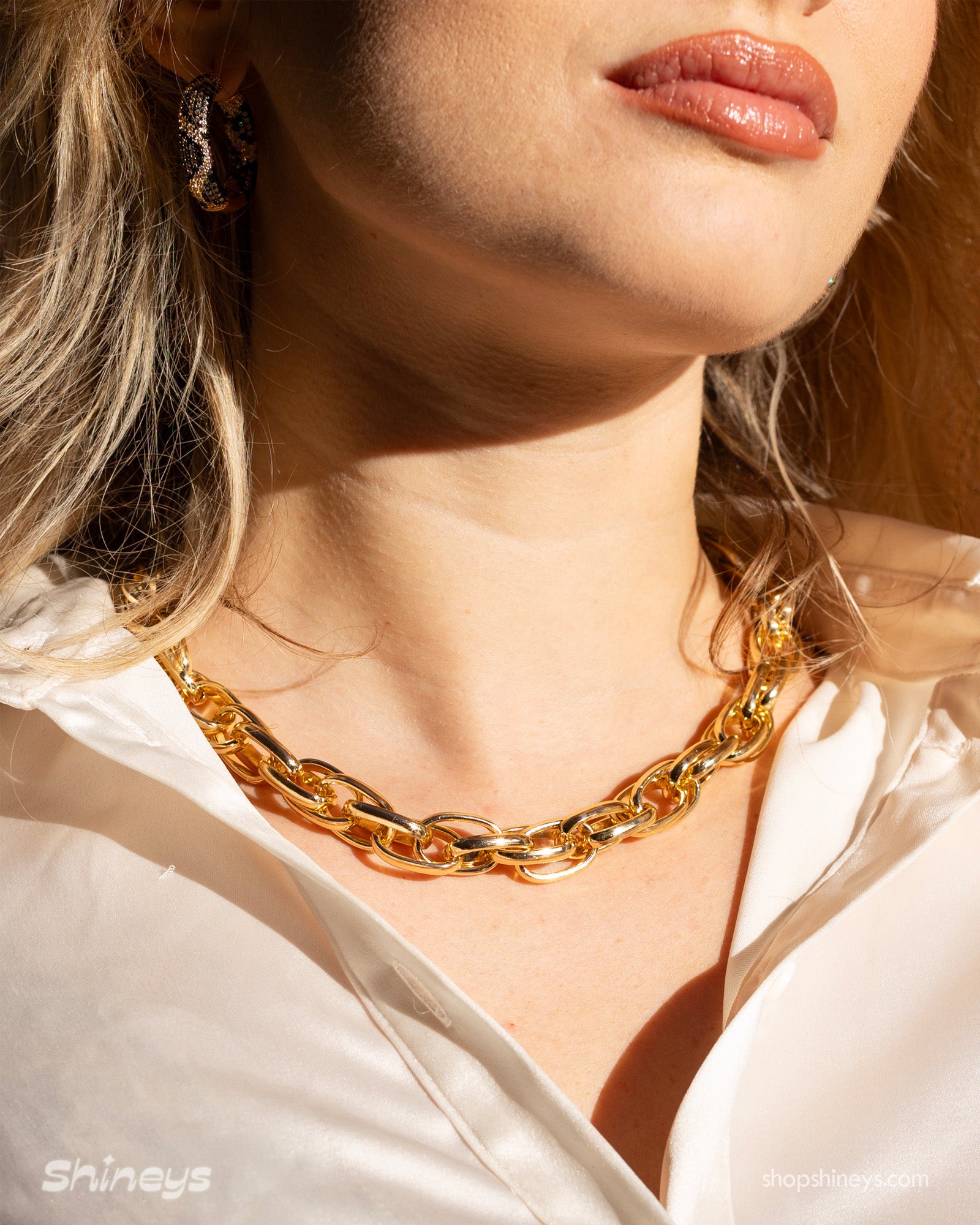 A necklace of interwoven gold-tone links in a sleek rope-style design for a classic, statement look