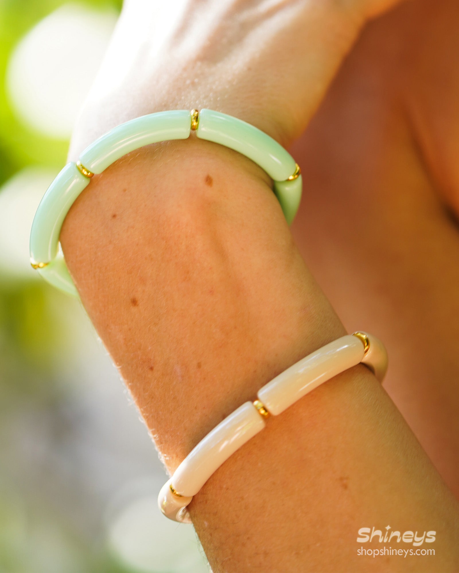 A playful ocean bangle with smooth, curved acrylic segments and delicate golden connectors