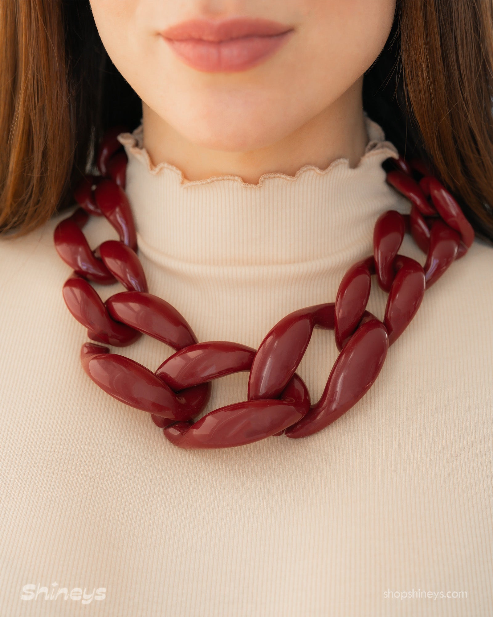 A wine-red necklace with a dynamic progression of oversized, high-shine links for a sculptural look