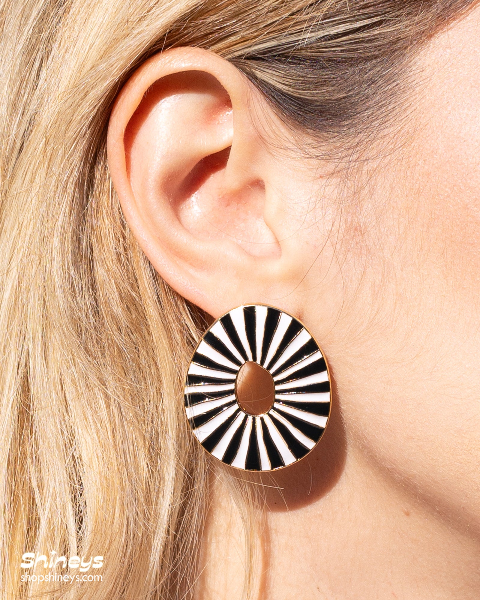 Black oval earrings with radiant enamel stripes in a sunburst pattern for a retro glamour look