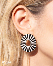 Black oval earrings with radiant enamel stripes in a sunburst pattern for a retro glamour look