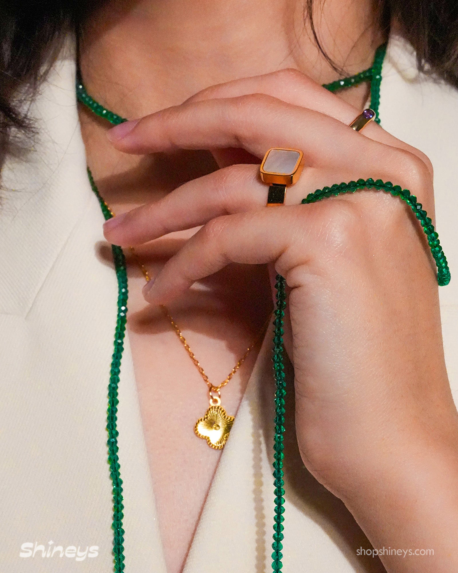 The Claire Green Rope Necklace, Naya Clover Necklace, and Nimbus Mother-of-Pearl Ring