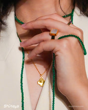 The Claire Green Rope Necklace, Naya Clover Necklace, and Nimbus Mother-of-Pearl Ring
