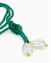 An ultra-lightweight, rope-style necklace strung with fine, deep green seed beads and luminous pearl ends