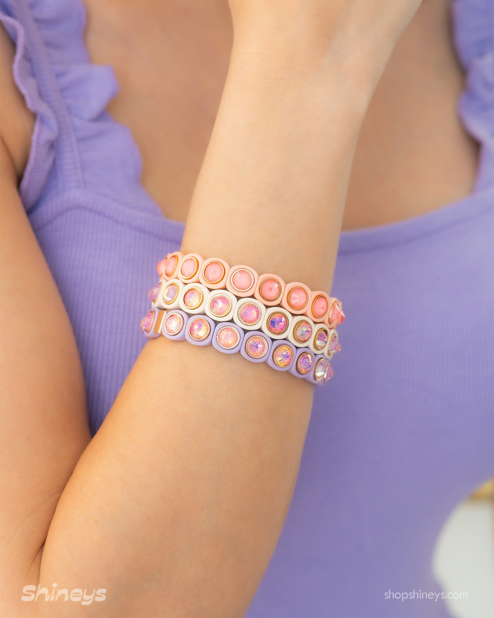 A lime-blue stretch bracelet with glossy links set with iridescent crystal stones for a playful flair