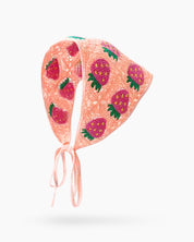 A hand-crocheted headscarf in apricot with adorable strawberry motifs for a sweet, whimsical look