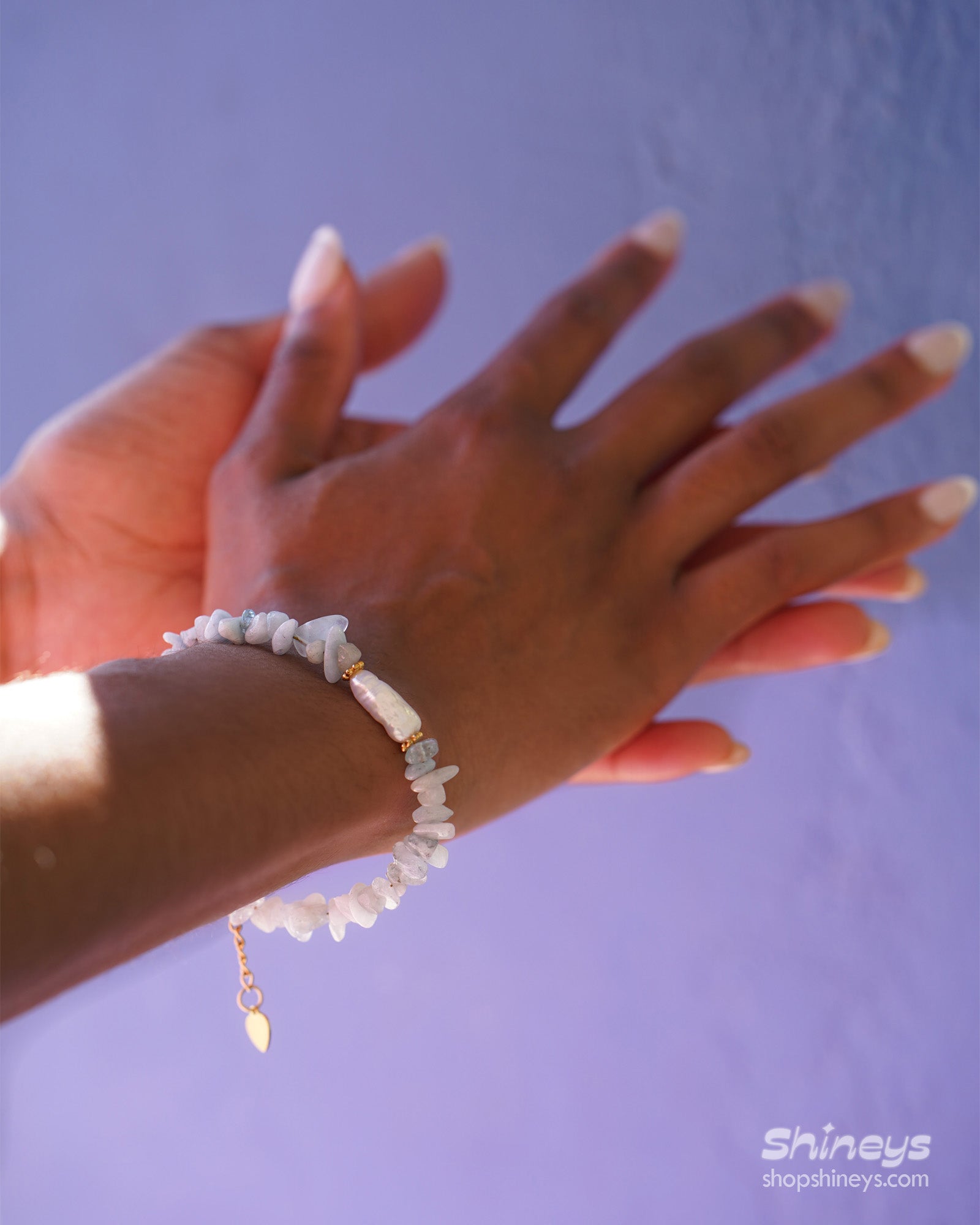 A bracelet of natural light-blue quartz chips, anchored by a luminous baroque pearl at its center