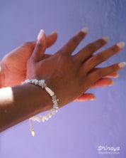 A bracelet of natural light-blue quartz chips, anchored by a luminous baroque pearl at its center