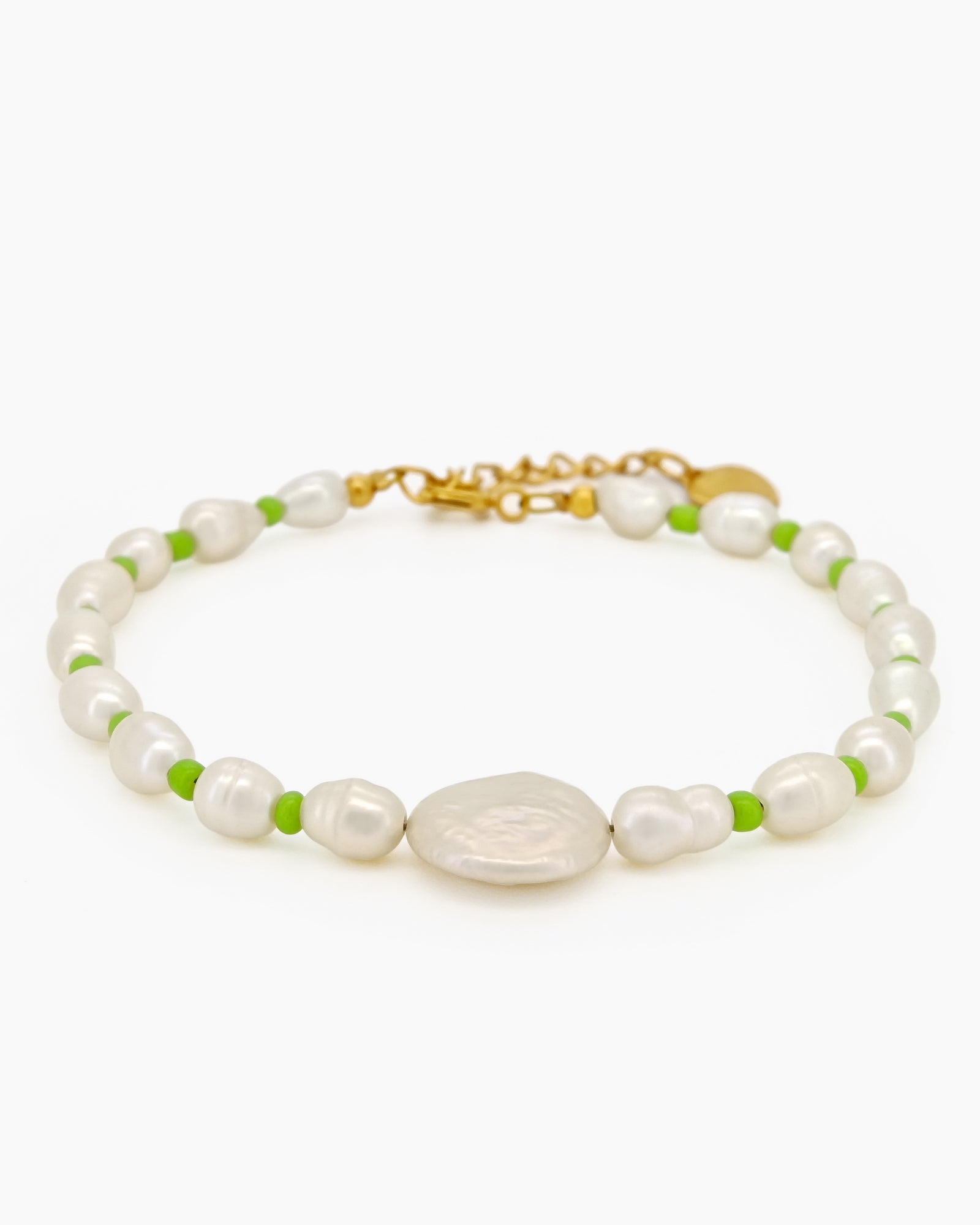 A bracelet of lustrous freshwater pearls, gently accented by vivid green seed beads for a fresh pop of color