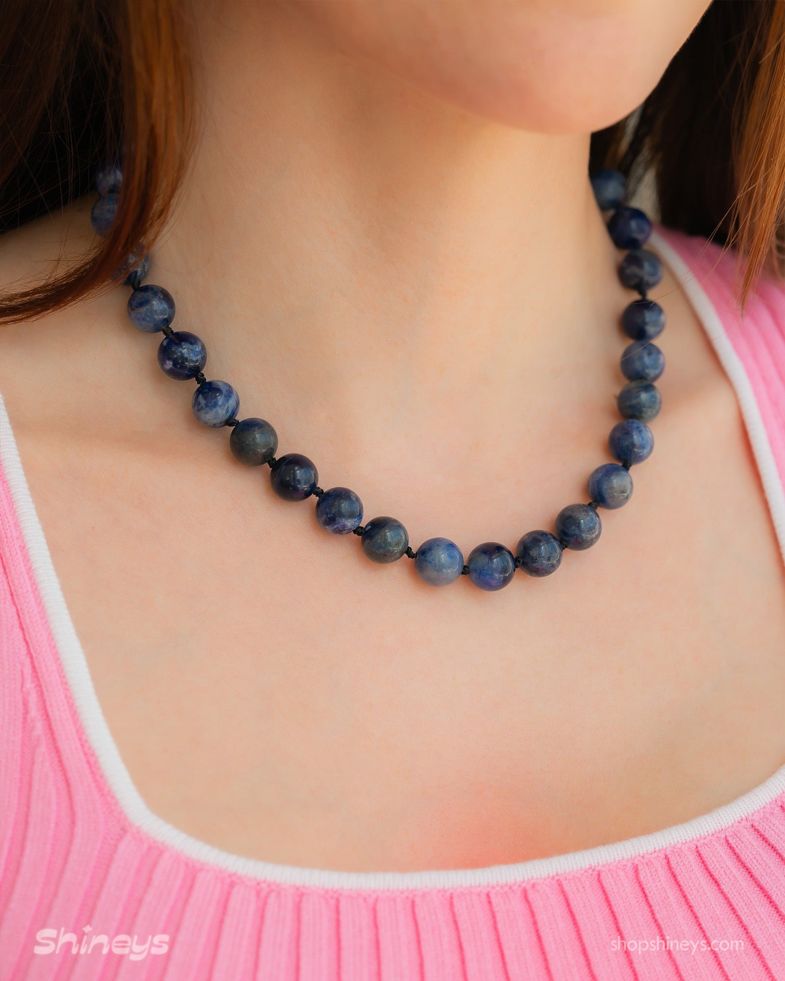 A hand-knotted necklace of deep blue lapis lazuli stones, each speckled like a miniature galaxy